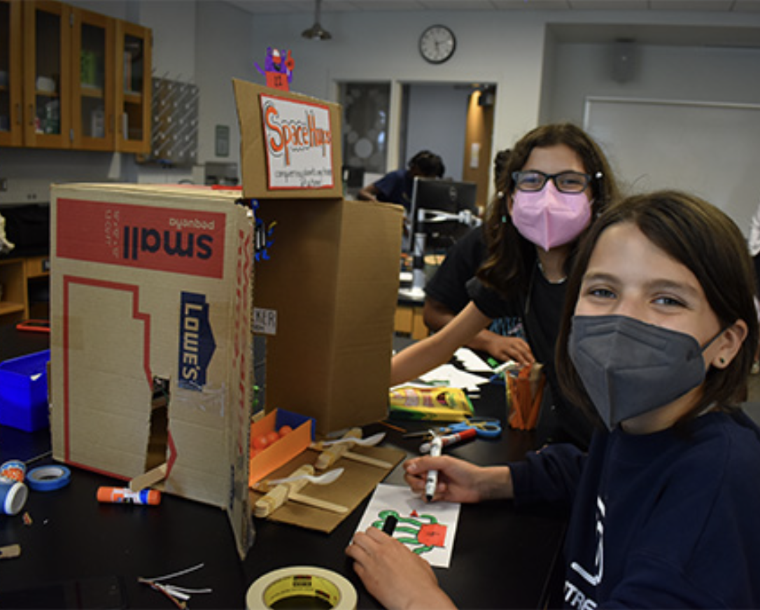 Students building a model in a lab